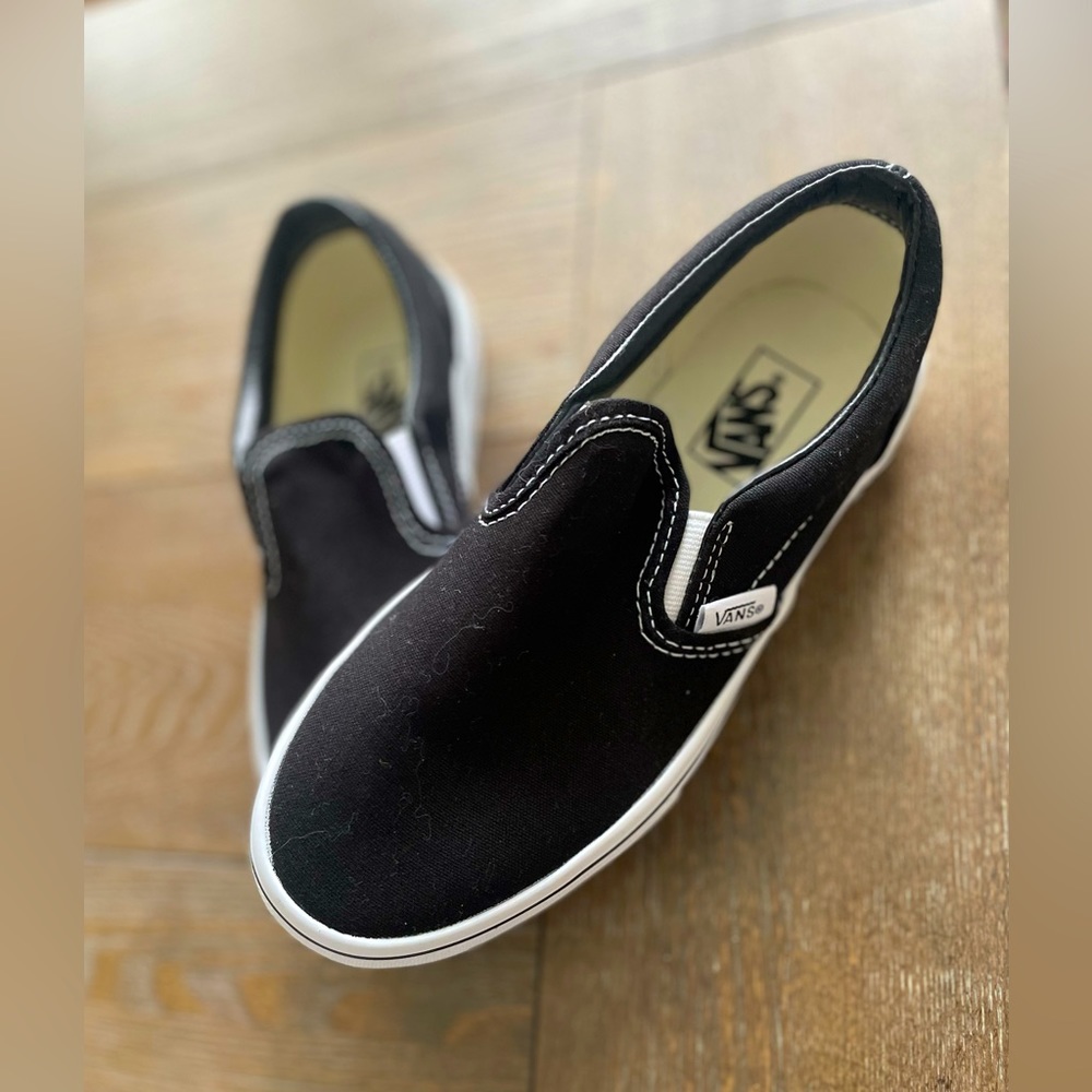 Vans . unboxed new black classic slip ons.